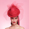 Woman wearing a red hat with a pink background